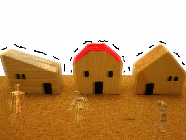地震で震えている３つの模型の家 